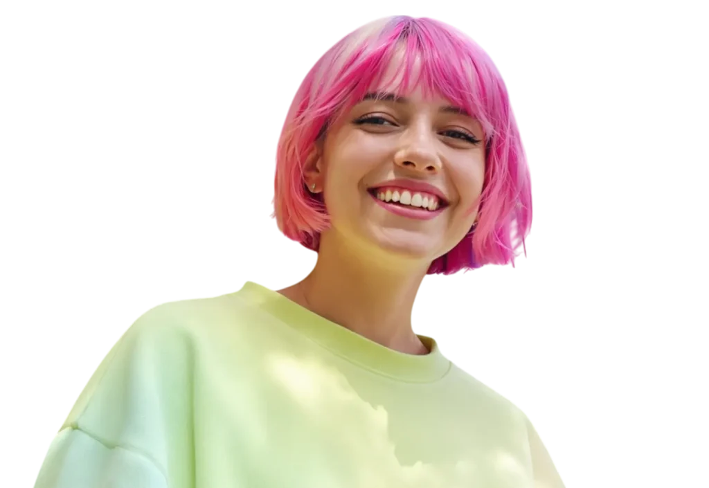 Person with pink hair, wearing a light green top, smiling at the camera against a plain background.
